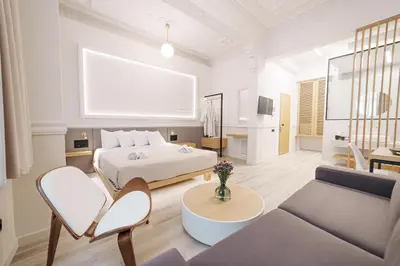 a bedroom with a bed and a living room at Agora Athens Suites in Athens
