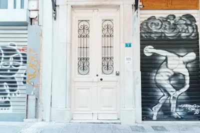 a white door with a painting of a woman on it at Agora Athens Suites in Athens