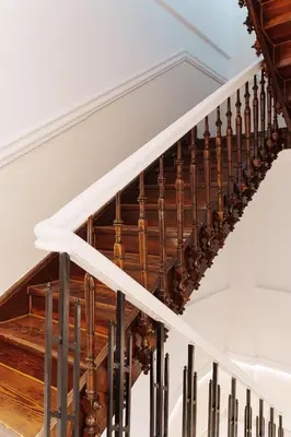 a spiral staircase with wood and metal railings at Agora Athens Suites in Athens