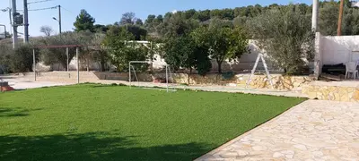 a field of green grass with a soccer goal at Gianni & Sophia airport house in Artemida