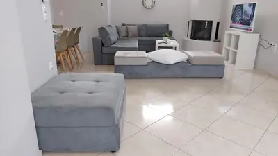 a living room with a couch and a tv at Gianni & Sophia airport house in Artemida
