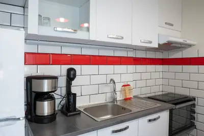 a kitchen with a sink and a coffee maker at The Athenian Penthouse Residence in Athens