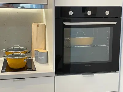 a microwave oven with two pots on a stove at mosaic art apartment in plaka in Athens