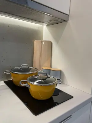 two pots and pans on a stove in a kitchen at mosaic art apartment in plaka in Athens