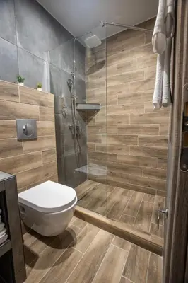 a bathroom with a toilet and a glass shower at Raise Averof Serviced Apartments in Athens