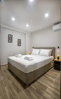 a bedroom with a large bed in a room at Raise Averof Serviced Apartments in Athens