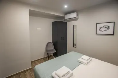 a bedroom with a bed with towels on it at Raise Averof Serviced Apartments in Athens