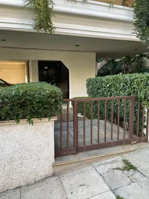 a wooden gate in front of a building at AIOLOS LUXURY alimos quiet apartment 1 in Athens