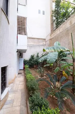 a courtyard of an apartment building with plants at AIOLOS LUXURY alimos quiet apartment 1 in Athens