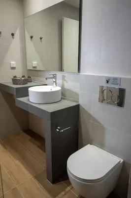 a bathroom with a sink and a toilet and a mirror at Athens Glance Boutique Apartments in Athens