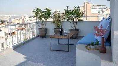 a balcony with a table and potted plants on it at Athens Glance Boutique Apartments in Athens