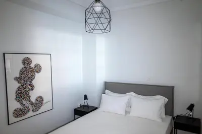 a bedroom with a bed and a picture on the wall at Athens Glance Boutique Apartments in Athens