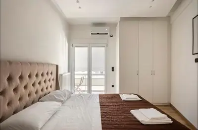 a bedroom with a bed with two towels on it at Nazar Apartment- in the center of Athens in Athens