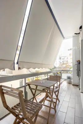 a balcony with a table and chairs on a ship at Nazar Apartment- in the center of Athens in Athens