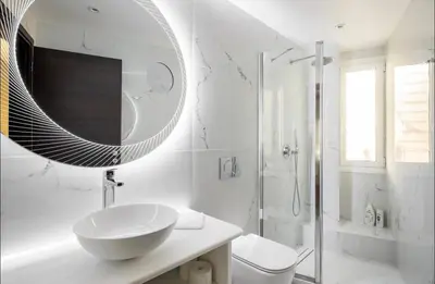 a white bathroom with a sink and a mirror at Nazar Apartment- in the center of Athens in Athens