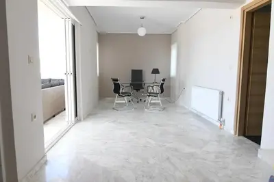 a hallway with a table and chairs in a room at Villa Niso in Anavissos