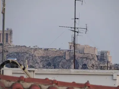 a view of a hill with a communications antenna at Αfrodite! Roof top studio--Wonderful city view in Athens