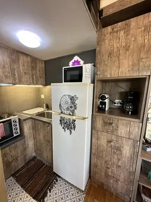 a refrigerator with a sticker on it in a kitchen at Αfrodite! Roof top studio--Wonderful city view in Athens