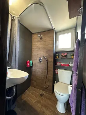 a bathroom with a toilet and a sink and a shower at Αfrodite! Roof top studio--Wonderful city view in Athens
