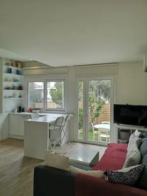 a kitchen and living room with a couch and a table at Riviera Studio in Athens