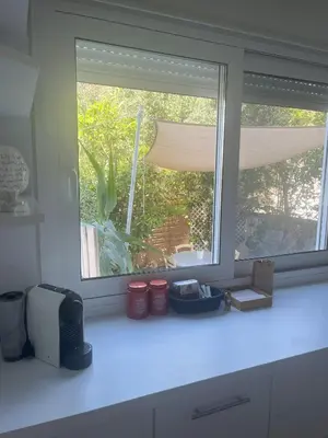 a kitchen counter with a window in a kitchen at Riviera Studio in Athens