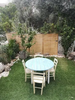 a blue table and chairs in a yard at Riviera Studio in Athens