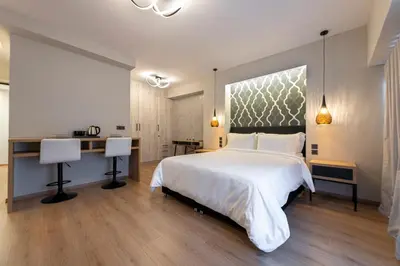 a bedroom with a white bed and a desk at Ethereal Athεns in Athens