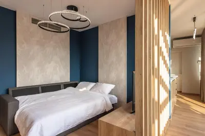 a bedroom with a white bed and blue walls at Ethereal Athεns in Athens