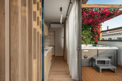 a kitchen with a tub and a sink and a window at Ethereal Athεns in Athens