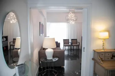 a room with a mirror and a table with a lamp at Konstantinos Stylish Brand New Apt in the heart of Athens in Athens