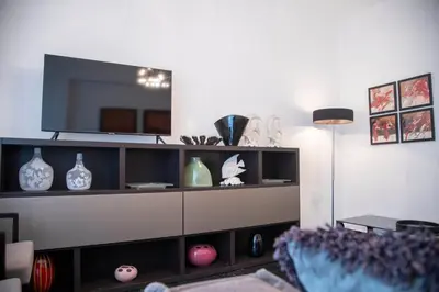 a living room with a entertainment center with a tv at Konstantinos Stylish Brand New Apt in the heart of Athens in Athens