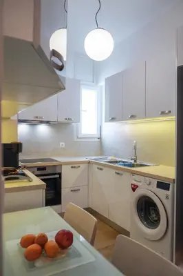 a kitchen with a plate of fruit on a table at Konstantinos Stylish Brand New Apt in the heart of Athens in Athens