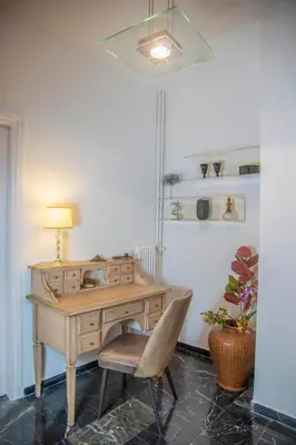 a desk with a chair and a lamp in a room at Konstantinos Stylish Brand New Apt in the heart of Athens in Athens