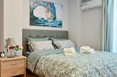 a bedroom with a bed with towels on it at Charming apartment with a sea view terrace (F1) in Piraeus