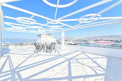 a patio with chairs and a table on a balcony at Charming apartment with a sea view terrace (F1) in Piraeus