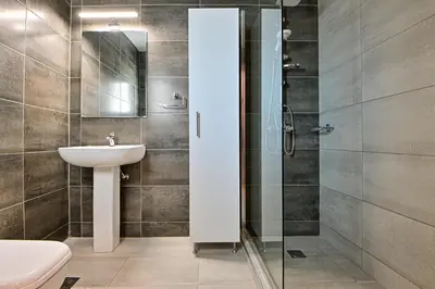 a bathroom with a sink and a shower at Charming apartment with a sea view terrace (F1) in Piraeus