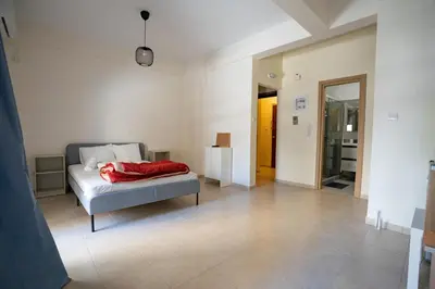 a bedroom with a bed with a red blanket on it at Ag Ioannis m station 1 bed for 2 pers by MPS in Athens