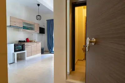 a kitchen with a door open to a kitchen with a counter at Ag Ioannis m station 1 bed for 2 pers by MPS in Athens