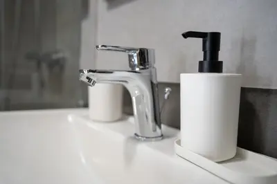 a bathroom sink with a faucet and a paper towel holder at Ag Ioannis m station 1 bed for 2 pers by MPS in Athens