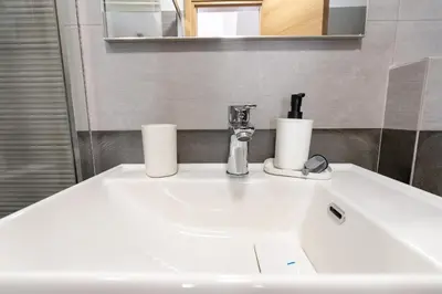 a bathroom sink with two rolls of toilet paper on it at Ag Ioannis m station 1 bed for 2 pers by MPS in Athens