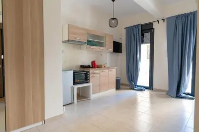 a kitchen with blue drapes and a white refrigerator at Ag Ioannis m station 1 bed for 2 pers by MPS in Athens