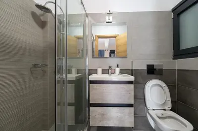 a bathroom with a toilet and a sink and a shower at Ag Ioannis m station 1 bed for 2 pers by MPS in Athens