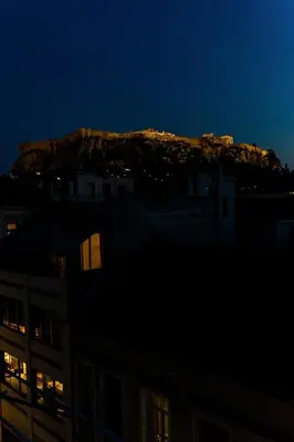 a view of a mountain at night at Luxury penthouse , breathtaking Acropolis view in Athens
