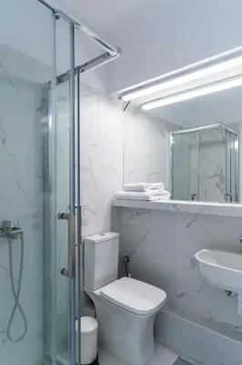 a bathroom with a toilet and a sink and a shower at Luxury penthouse , breathtaking Acropolis view in Athens