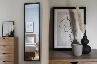 a mirror in a room with a bed and a dresser at Dazzling 1BR Apartment in Koukaki by UPSTREET in Athens