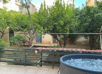 a tub of water sitting on top of a balcony at 2BDRM Glyfada Residence - Jacuzzi, Garden & Parking in Athens