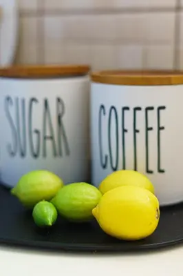 a plate with lemons and coffee cups on a table at 2BDRM Glyfada Residence - Jacuzzi, Garden & Parking in Athens