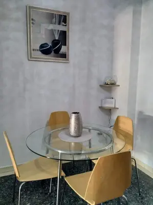 a dining room with a glass table and chairs at A convenient apartment in the heart of Athens in Athens