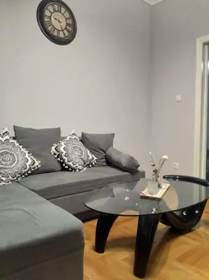 a living room with a couch and a glass table at A convenient apartment in the heart of Athens in Athens