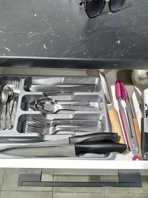 a drawer filled with silver utensils in a drawer at A convenient apartment in the heart of Athens in Athens